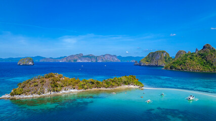 Aerail view of  tropical exotic island sand bar separating sea in two with turquoise  in El Nido, Palawan, Philippines.