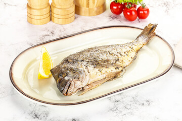 Baked Dorado fish served lemon