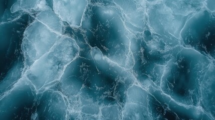 Fototapeta premium A drone shot from above of an ice field with intricate cracks and lines, creating an abstract image full of movement and beauty.