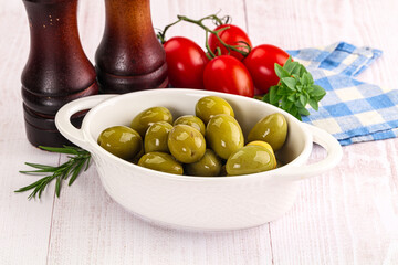 Green marinated olives in the bowl
