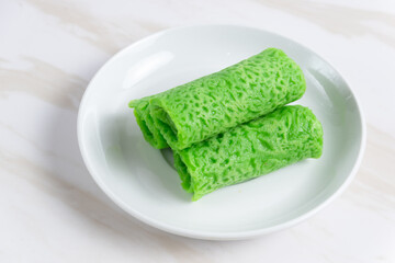 Kue dadar gulung or rolled pancake or sweet coconut pancake, an Indonesian dessert made from wheat flour with grated coconut mixed with palm sugar. 
