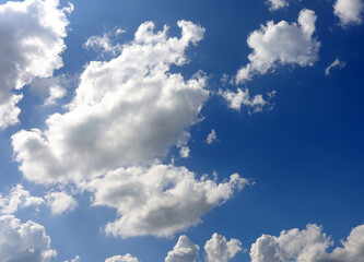 The sky is bright blue and the clouds are white. The sky during the day has pure white clouds like cotton. The sky background.