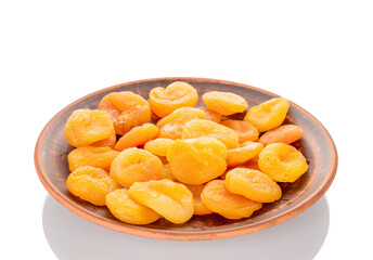 Sweet dried apricots on a ceramic plate, close-up, isolated on a white background.