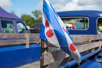 Closeup of a Frisian flag on an old American oldtimer pickup truck in Menaam Friesland The...