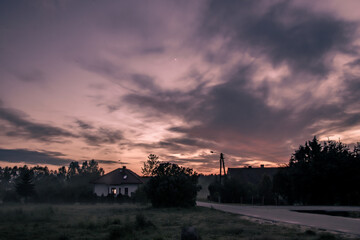 Sunset in village with red sky