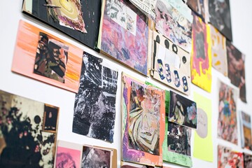 A vibrant assortment of artistic works is presented innovatively against a light backdrop, highlighting a variety of styles, hues, and themes that express distinctive viewpoints.