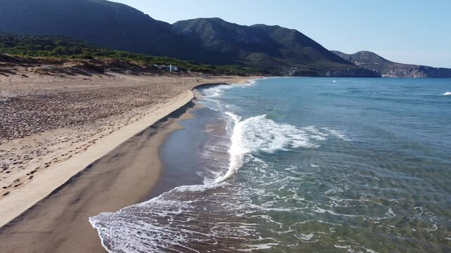 Sardinian sea waves crashing on the beach of Portixeddu in Buggerru