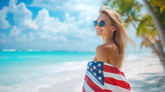 Young happy woman in US flag walking on tropical beach on sunny day