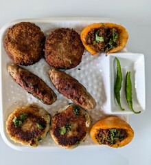 Meat patties and kababs with spicy vegetables 