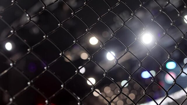 MMA cage arena lit by spotlights, Mixed martial arts fight night event