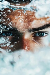 Man's eye and brow underwater with bubbles.