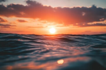 Obraz premium Vibrant Sunset Over Ocean Waves - Stunning sunset over the ocean, capturing warm orange hues reflecting on the water. Symbolizing peace, tranquility, nature, beauty, and serenity.