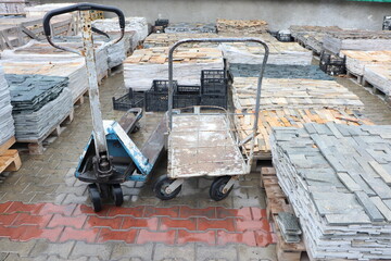 Sturdy hand carts are used effectively among the paved stones to facilitate various tasks