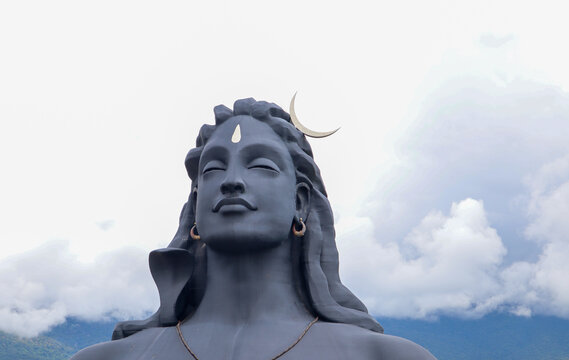  The magnificent sculpture 'Adi Yogi' or Lord Shiva in dark grey shades against the cloudscape at ISHA ashram near Coimbatore in Tamil Nadu, India.