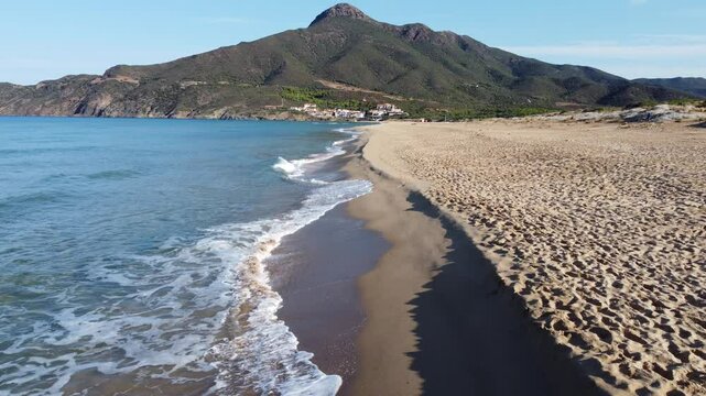 Sardinian sea waves crashing on the beach of Portixeddu in Buggerru
