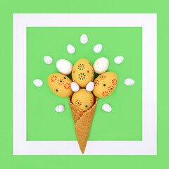 Surreal Easter background design with ice cream cone and decorated eggs on green background with white frame. Seasonal fun abstract composition.