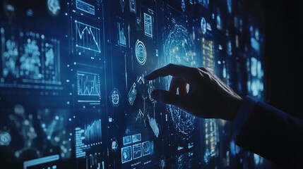 A hand gestures across a large, dark blue screen filled with glowing charts, graphs, and data points