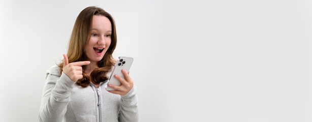 young teenage girl typing on laptop. stand on white background hold gadget in hands search internet links learn online. order online delivery