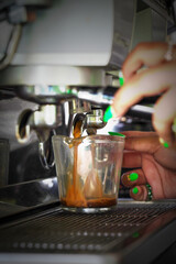 cup with hot coffee on espresso machine