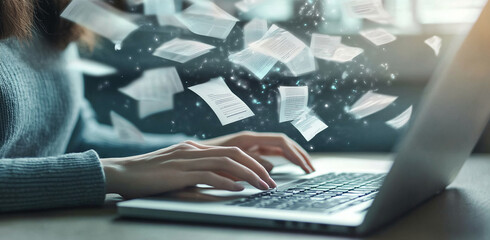 Hands type on a laptop keyboard