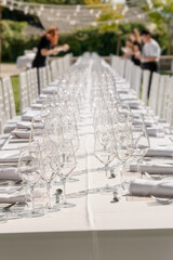Served wedding table with plates, white chairs, napkins and wine glasses