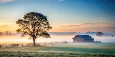 Naklejka premium Serene Farm Landscape: Foggy Morning with a Majestic Tree in a Lush Field, Capturing the Tranquility of Nature and Architectural Elements of Rural Life