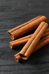 Cinnamon sticks on a wooden background