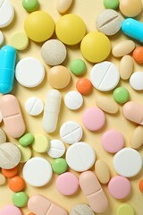 Various medicine pills and capsules on color background 