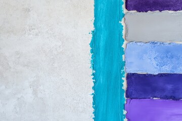 Create a swatch of blue, turquoise, purple, and gray-blue in a cool style on a light gray travertine background 