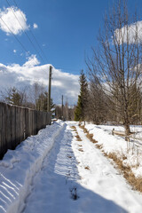 Snowy path with a fence on the side