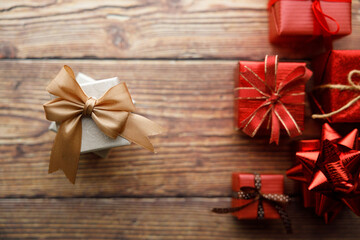 Assorted artisanal gift boxes on wooden background.
