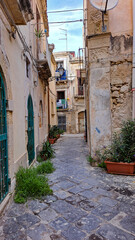 grass on a charming street in Syracuse Sicily