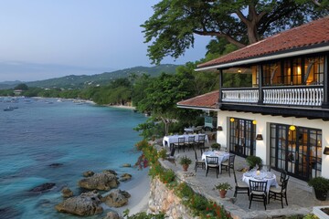 Fototapeta premium A serene coastal restaurant alongside clear turquoise waters at dusk in a tropical paradise