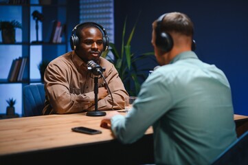 Show host and guest meeting to stream podcast episode together, creating online content with live...