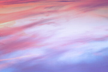 Twilight sky with effect of light in pastel pink, coral, orange, blue tones. Colorful sunset of soft clouds. Background