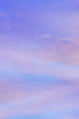 Sky with soft and fluffy pastel orange pink and blue colored clouds. Sunset background. Nature. sunrise. Vertical