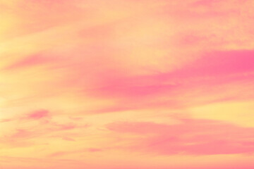 Sky with soft and fluffy pastel coral orange pink and blue colored clouds. Sunset background. Nature. sunrise. Instagram toned style