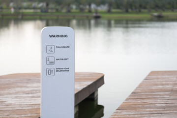 Warning signs are installed along the waterfront. Caution signs are installed along the edge of the pond.