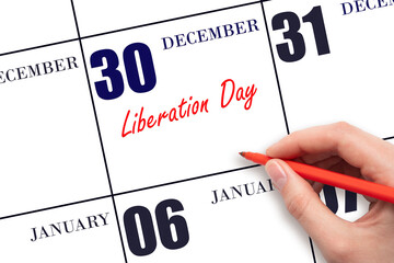 December 30. Hand writing text Liberation Day on calendar date. Save the date.