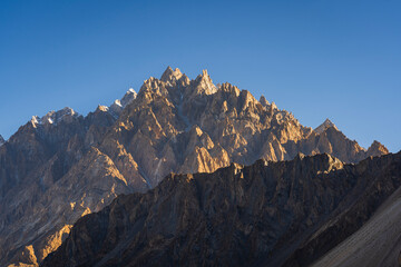 Scenic landscape view of Tupopdan peak aka Passu cathedral or Passu cones at sunrise, Hunza valley, Hunza Nagar, Gilgit Baltistan, Pakistan