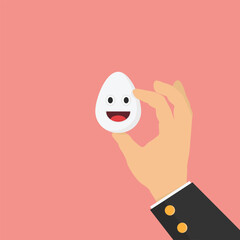 Hand holding a white egg with a happy face. Concept of healthy or nutritious food