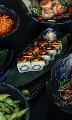 Japanese dishes on plates, beautiful presentation of sushi and wok and rice with vegetables and other Asian food in Asian style