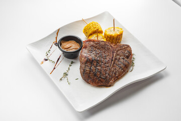 Steaks with garnish and sauces