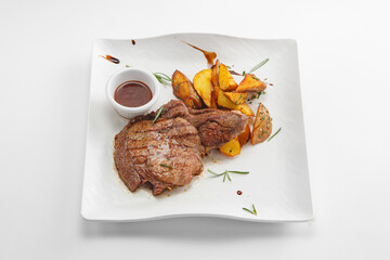Steaks with garnish and sauces