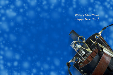 Hairdressing tools on a dark blue background. New Year, Christmas card. Congratulations to hairdressers on the New Year and Christmas.