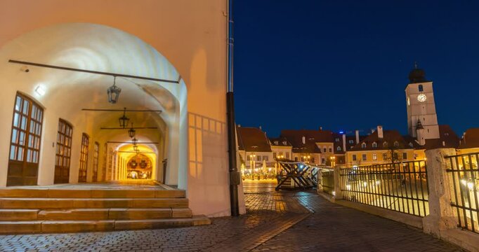 Sibiu, Romania - October 20, 2024: Night view to the Piata Mica street and small square. Timelapse, slide transition.