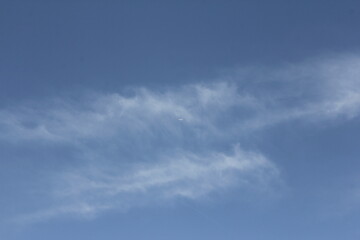 Clear blue sky over a desert landscape, adding calmness and simplicity to the vast, open scene.