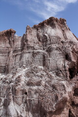 Tall, rugged cliffs in a desert setting, emphasizing the dramatic and untouched beauty of the natural landscape.