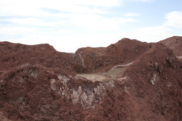Close-up view of eroded rock with natural textures, forming a rugged, weathered appearance under sunlight.