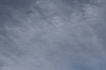 Dark clouds drifting over distant mountains, creating a dramatic and moody atmosphere in a natural landscape.